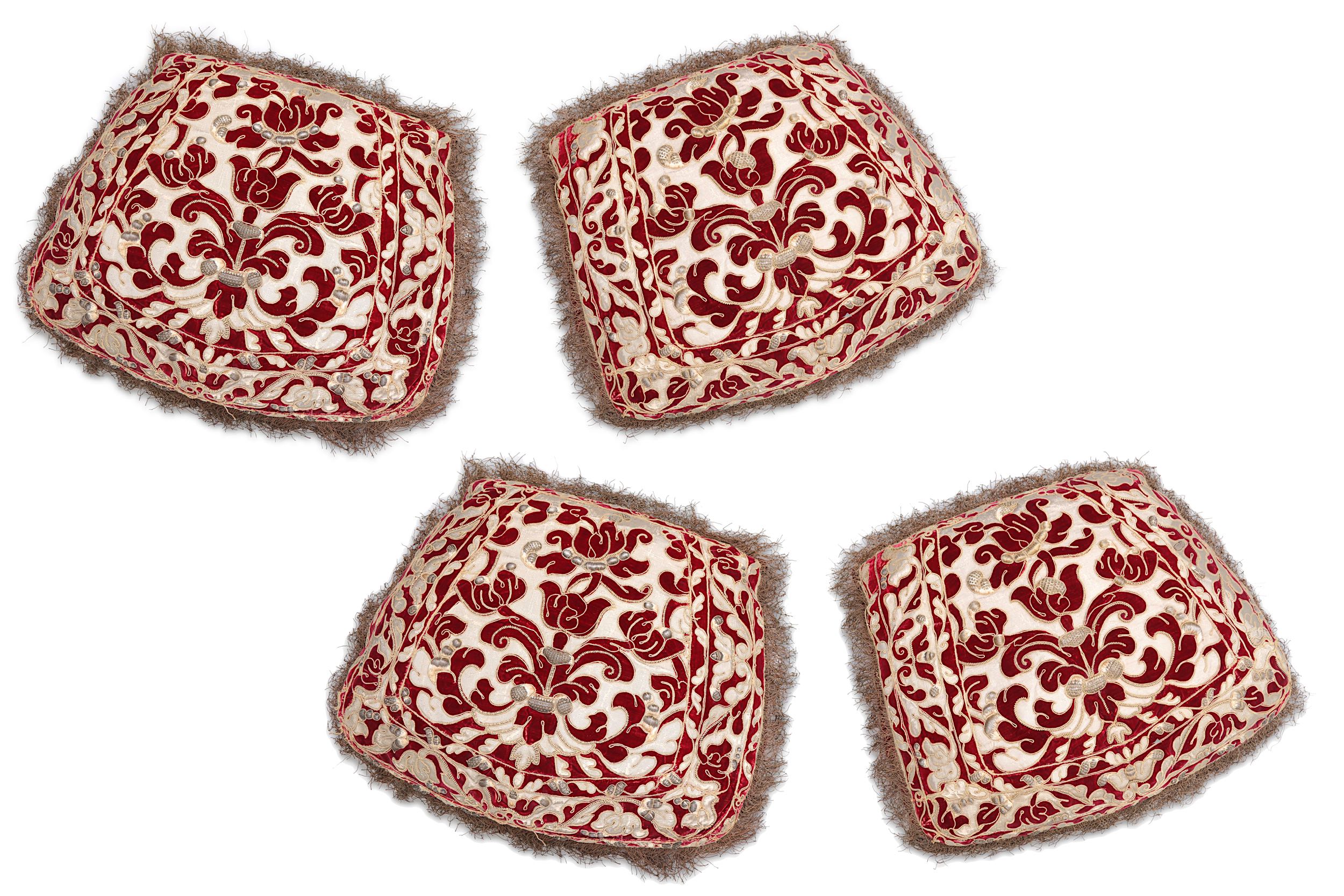 FOUR OTTOMAN-STYLE RED VELVET AND GOLD THREAD APPLIQUE CUSHIONS.