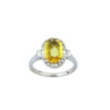 A yellow sapphire and diamond cluster ring