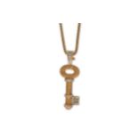 A diamond and yellow sapphire key pendant necklace, by Theo Fennell