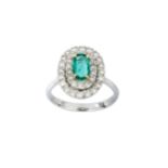 An emerald and diamond ring