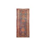 AN ANTIQUE KAZAK RUG, SOUTH CAUCASUS approx: 9ft.2in x 4ft.(279cm. x 122cm.) The light blue field