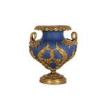 A LOUIS XVI STYLE BLUE PORCELAIN AND GILT BRONZE MOUNTED URN