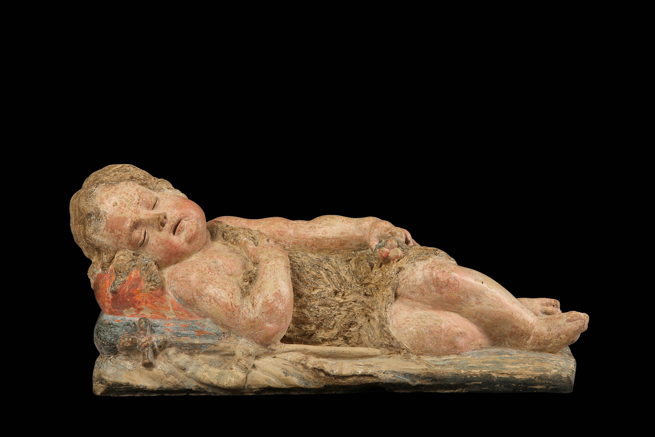 A 17TH / 18TH CENTURY ITALIAN POLYCHROME TERRACOTTA FIGURE OF ST JOHN THE BAPTIST SLEEPING