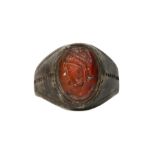 A LARGE PERSIAN SILVER RING WITH CARNELIAN INTAGLIO Circa 1st Millennium B.C. With a flattened shank