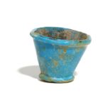 AN EGYPTIAN BLUE GLASS VESSEL Late Period, Circa 664 - 332 B.C. The small bright blue vessel, with a