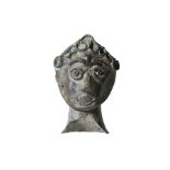 A NEAR EASTERN SILVER HEAD Circa 1st Millennium B.C. – 1st Millennium A.D. Of highly stylised