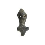 A CANAANITE BONZE IDOL Circa 1st Century B.C. The stylised figure, wearing a conical hat, with