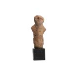 A VINCA TERRACOTTA STATUETTE Circa 4th Century B.C. Of rudimentary form, with a cylindrical body,