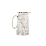 A late Victorian sterling silver hot milk/water jug, London 1886 by James Garrard