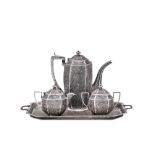 An early 20th Century Anglo - Indian Raj unmarked silver three-piece coffee service on twin-handled