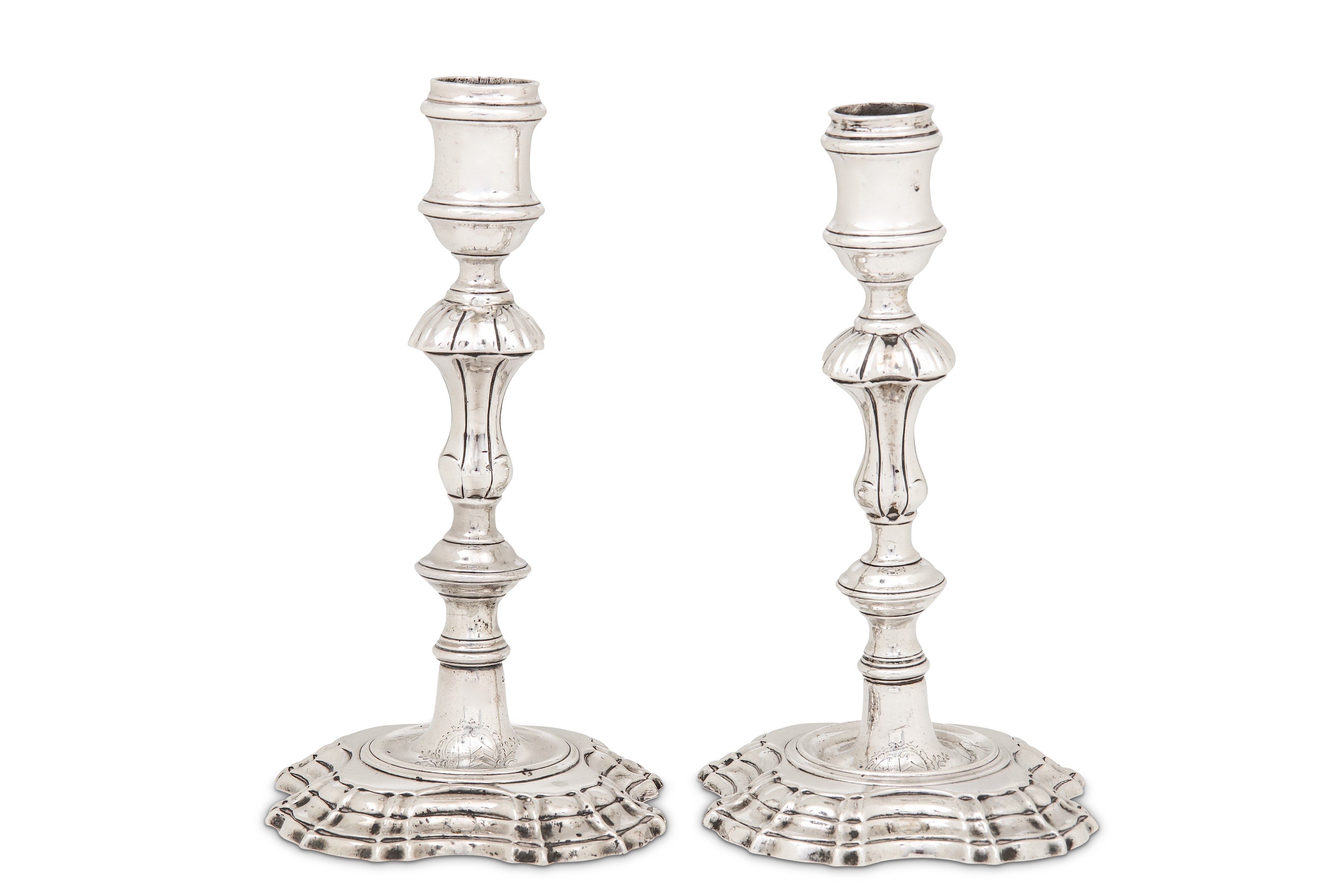 A matched pair of George II/III sterling silver candlesticks, London 1747 by John Cafe and London 17