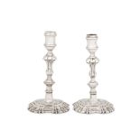A matched pair of George II/III sterling silver candlesticks, London 1747 by John Cafe and London 17