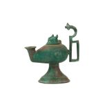 A FOOTED BRONZE OIL LAMP