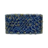 A BLUE-GLAZED MOULDED STONEPASTE BRICK