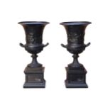 A large pair of antique style resin campana form urns