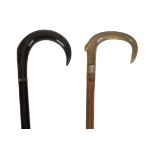 Two early 20th Century crook handled wood walking sticks, both possibly rhino horn,