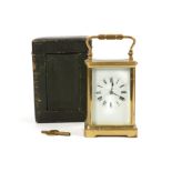 A late 19th / early 20th century French brass striking carriage clock with travelling case