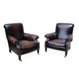 A pair of modern brown leather upholstered easy arm chairs