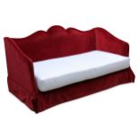 A contemporary red velvet upholstered cloud back day bed