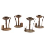 Four Arts and Crafts wrought iron candlesticks and matchbox holders by Goburg, circa 1905,