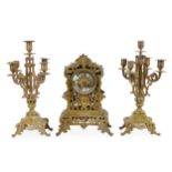 A French brass clock garniture, with striking movement,