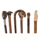 Six walking sticks each with carved novelty handles