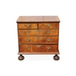 A George I walnut chest of two short and three long drawers