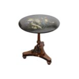 A decorative circular snap top occasional table