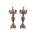 A pair of rouge marble based spelter five light candleabra,