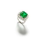 An emerald and diamond cluster ring