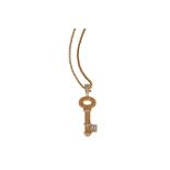 A diamond and yellow sapphire key pendant necklace, by Theo Fennell