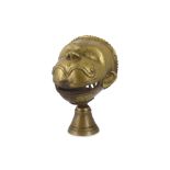 A BRASS FINIAL WITH SHRI HANUMAN'S FACE