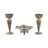 TWO SILVER REPOUSSÉ CANDLESTICKS AND A SMALL SERVING DISH