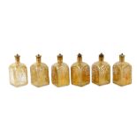 A SET OF SIX FINE MOULD-BLOWN AND GOLD-PAINTED SQUARE GLASS BOTTLES