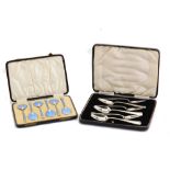 A cased set of six George V sterling silver gilt and guilloche enamel coffee or ice cream spoon set,