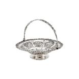 A George IV sterling silver swing handled cake basket, London probably 1828 by Rebecca Emes and Edwa