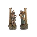 A LARGE PAIR OF EARLY 20TH CENTURY AUSTRIAN PAINTED TERRACOTTA FIGURES OF ARAB WATER CARRIERS