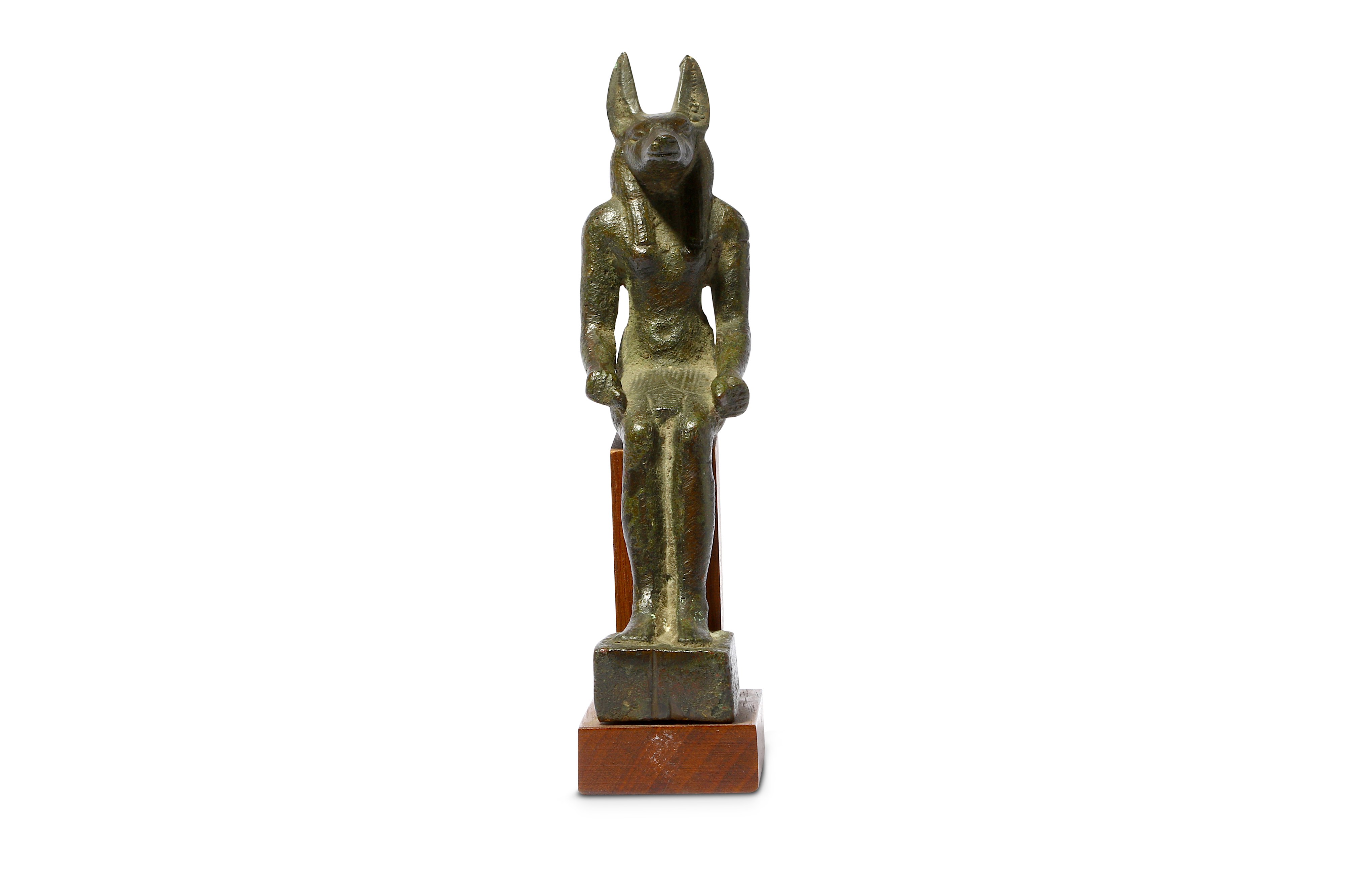 AN EGYPTIAN BRONZE FIGURE OF JACKAL-HEADED ANUBIS