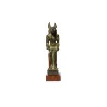 AN EGYPTIAN BRONZE FIGURE OF JACKAL-HEADED ANUBIS