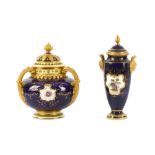 An early 20th Century Coalport three handled pot pourri of squat bulbous outline,