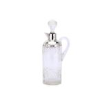 An Edwardian cut glass claret jug with Stering silver mounts