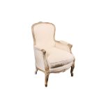 A French fauteuil, with white painted and parcel gilt carved frame