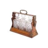 An Edwardian oak three bottle tantalus,