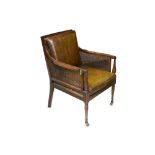 A Regency mahogany caned bergere library or reading chair,