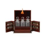 An early 20th the century sterling silver and cut glass fitted mahogany decanter drinks cabinet