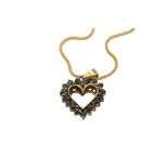 A gold and sapphire heart pendant necklace