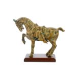 A modern patinated metal horse figure, modelled in the manner of a Tang Dynasty Chinese horse