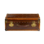 A French leather suitcase with brass mounts bearing blue label 'Breuil, Loire Articles de Voyage'