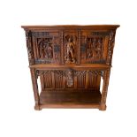 A 19th century Gothic Revival carved oak cupboard