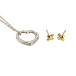 A pair of gold earstuds and a silver heart pendant necklace by Elsa Peretti for Tiffany & Co.